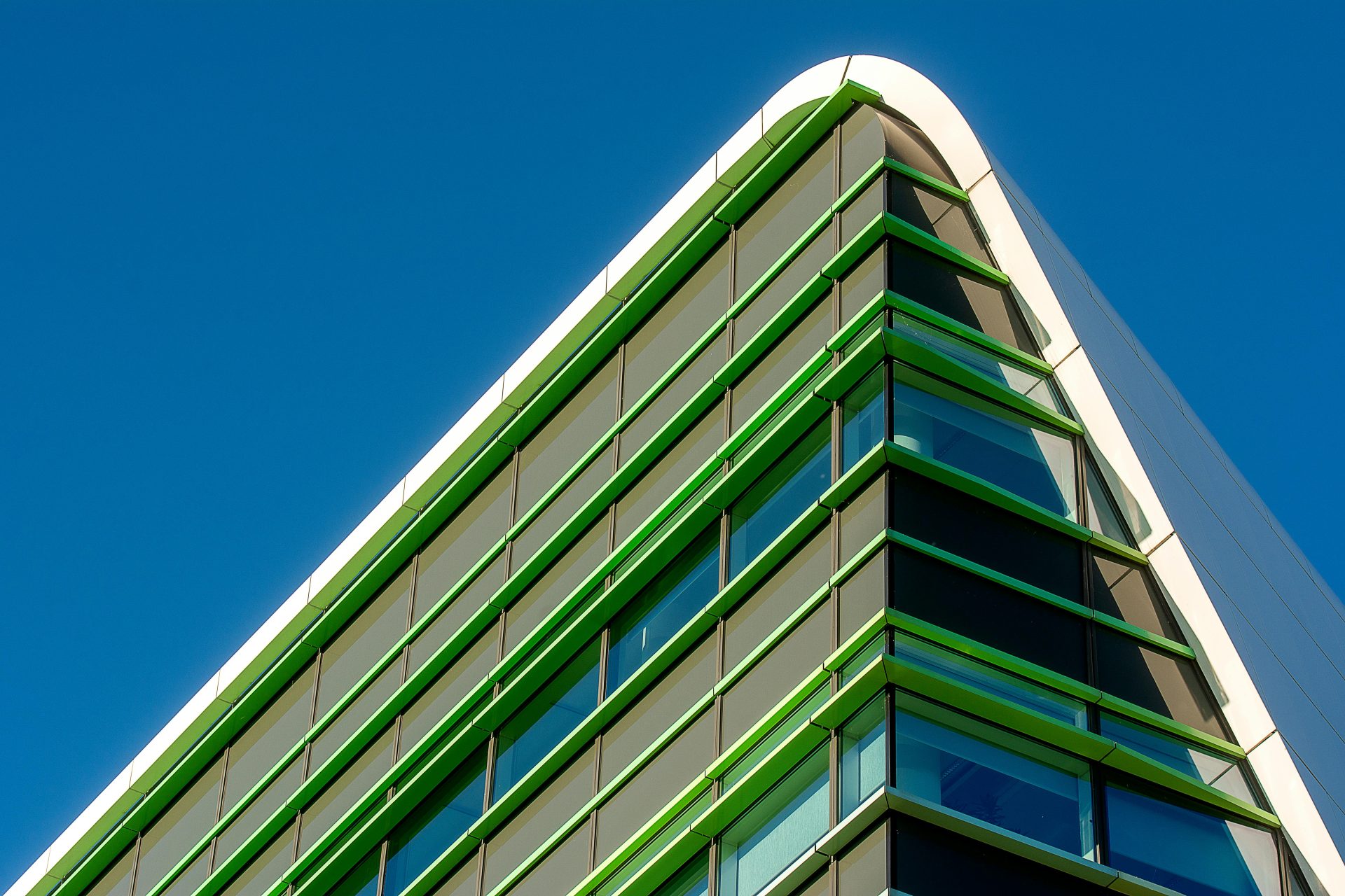 Sophisticated modern architectural facade showcasing geometric design under a clear blue sky.